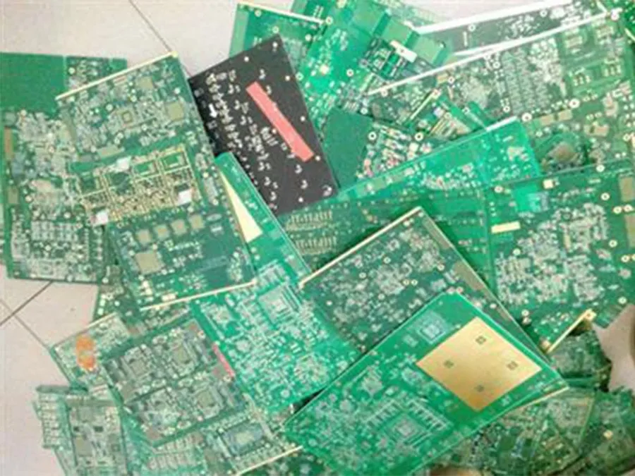 A pile of discarded PCBs ready for recycling.