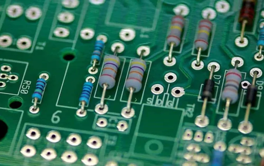 Close-up of solder pads on a circuit board with components.