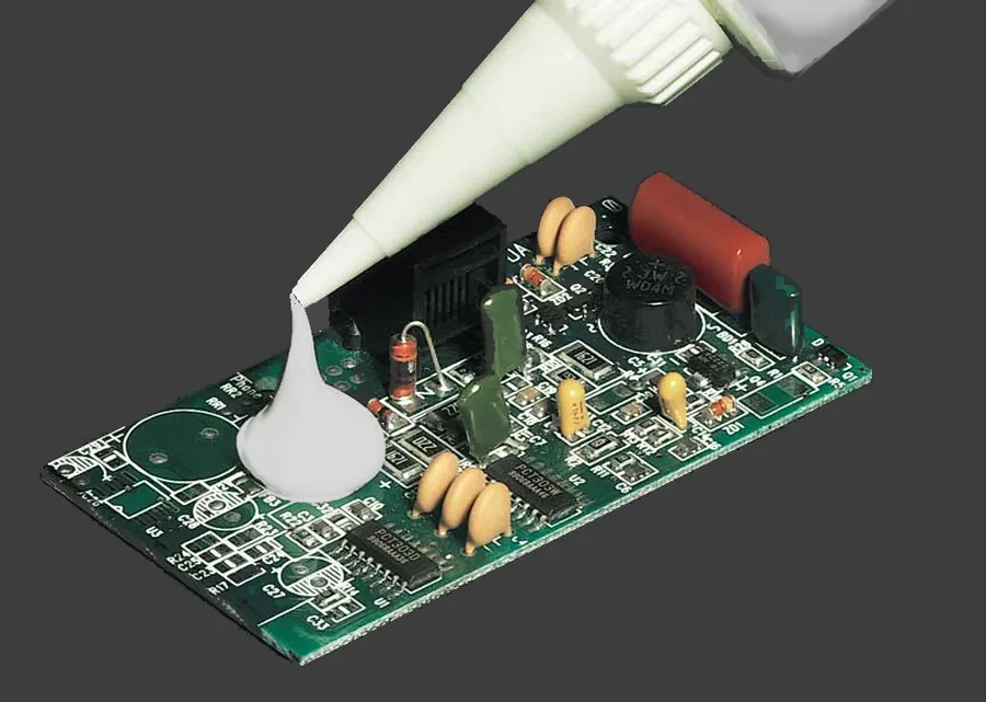 Silicone adhesive applied to a PCB for bonding.