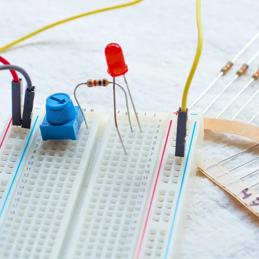 A breadboard with a 10k ohm resistor in a simple circuit.