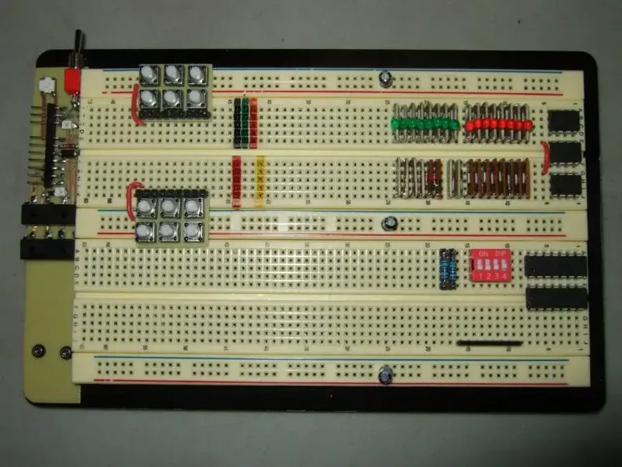 A side-by-side comparison of a PCB breadboard and a standard breadboard.