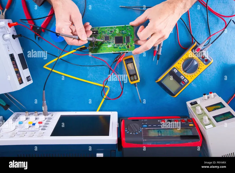 A person testing a prototype circuit with multimeter
