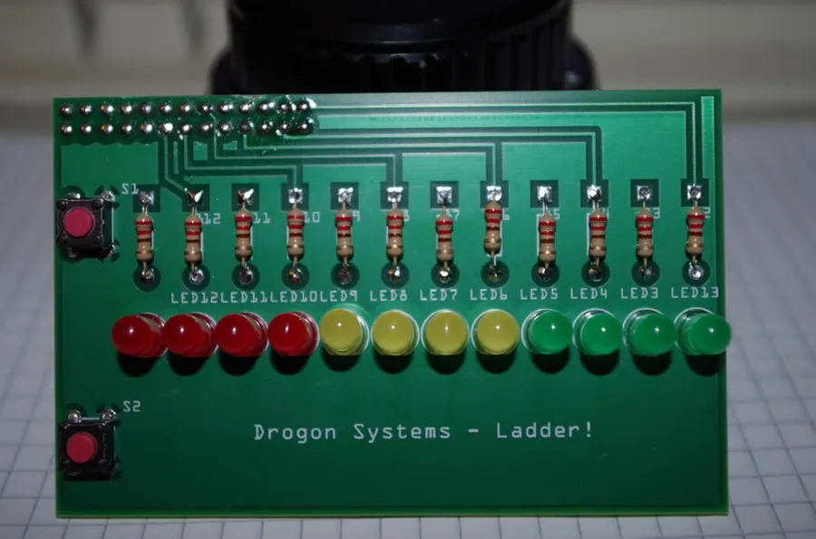 A printed circuit board project with components on the workbench.
