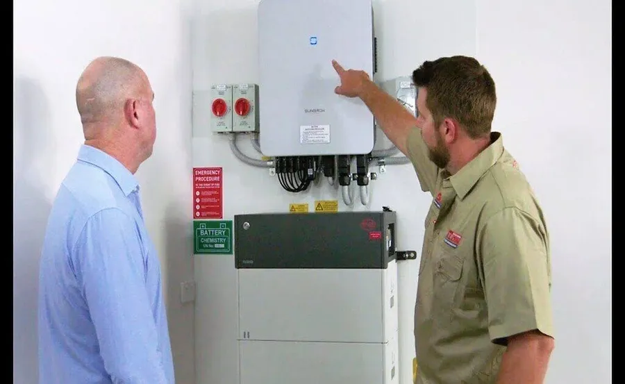 A person installing a power inverter.