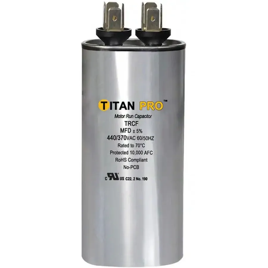 A run capacitor with its characteristic cylindrical shape.
