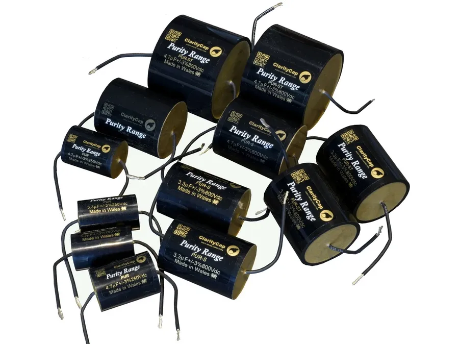A side-by-side comparison of capacitors from different brands, including an Elna capacitor.