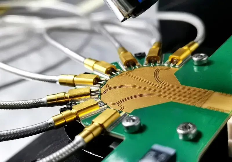 An electronic engineer testing a PCB with equipment